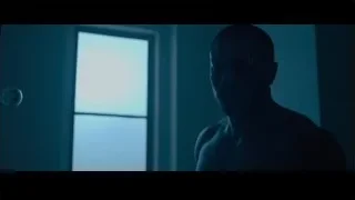 man standing in front of window in dark room — Creed 2