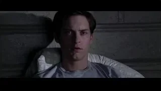 young man sitting in dark room — Spider Man 2