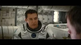 man in NASA space suit deep in thought — Interstellar