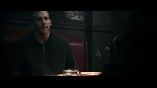 man deep in thought in dimly lit restaurant — Deadpool