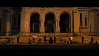 People in formal attire around fountain at grand building — John Wick: Chapter 4