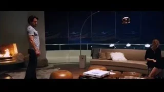 man and woman in living room with city view — Iron Man