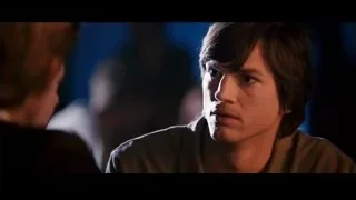 young man's face in dimly lit room — Jobs
