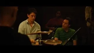 Young men playing drums in dimly lit room — Whiplash