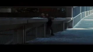 man with gun on snowy sidewalk — Batman: The Dark Knight Rises