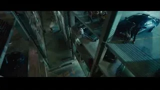 man working on car in parking garage — Furious Seven