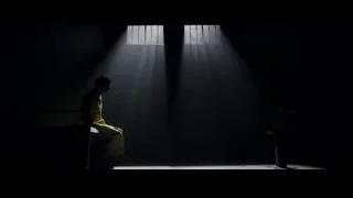 Person in yellow shirt in dimly lit room — The Amazing Spider Man