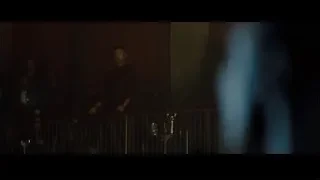 man speaking into microphone on balcony — Creed 2