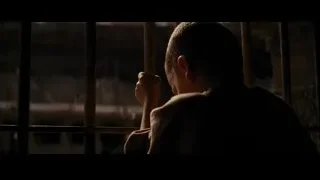 Young boy sitting behind bars looking out — Batman: The Dark Knight Rises