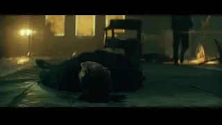 man lying unconscious on floor in dark room — John Wick