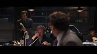 four men in office around desk — The Wolf Of Wall Street