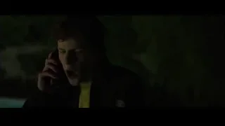 young man talking on phone in dark room — The Social Network