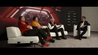 Four men in panel discussion on couch — F1