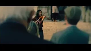 woman playing violin on stairs — John Wick: Chapter 4