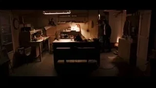 man in cluttered dimly lit room — Jobs