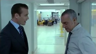 two men in suits conversing in hallway — Suits