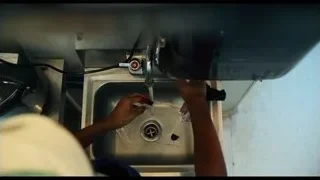 Hands cutting meat in kitchen sink — The Bear