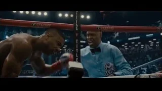 man in boxing ring with crowd — Creed 2