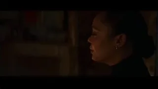 Woman looking out window in dim room — Creed 3