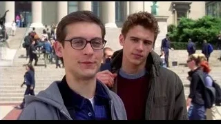 two young men posing by building columns — Spider Man