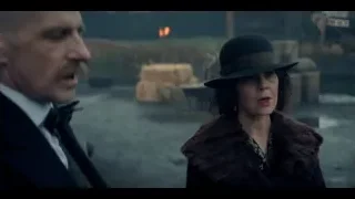man and woman standing in dimly lit room — Peaky Blinders