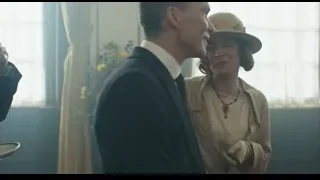 Woman giving gift to man in red room — Peaky Blinders
