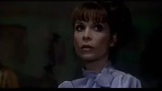 woman's serious face in dim room — Rocky III