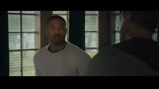 two men conversing by window with blinds — Creed 2