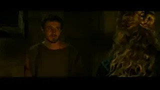man and woman standing in dimly lit room — Gladiator 2