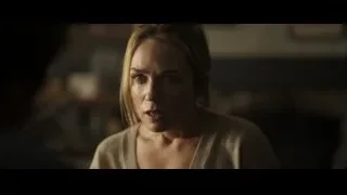 Blonde woman's serious face in dim room — F1