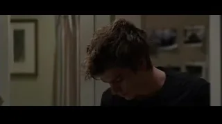 young man by door looking at reflection — The Amazing Spider Man