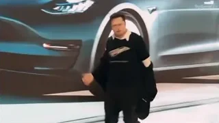 Man walking towards silver car indoors — Elon Musk: Return to Space