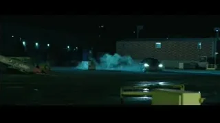 Black car driving on wet street at night — John Wick