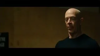 Bald man's face in dimly lit room — Whiplash