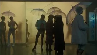 people holding umbrellas in front of rainy window — Blade Runner 2049