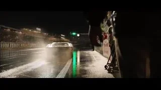 cars racing on wet track at night — Ford v Ferrari