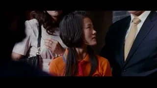 young girl in orange shirt in dim room — The Karate Kid