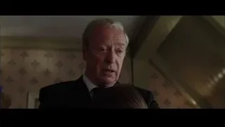 Older man in suit in floral wallpaper room — Batman