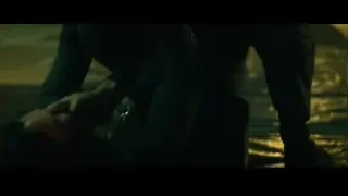 Person crouching with flashlight in dark room — John Wick