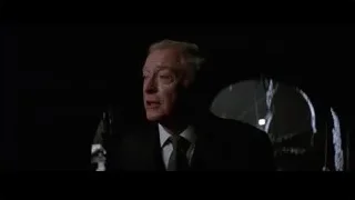 older man in suit in dark spotlight — Batman