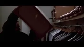 man in suit with rack of suits — American Psycho