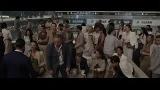 group of people in large room with Aldar signs — F1