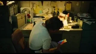 Man talking on phone at office desk — The Bear