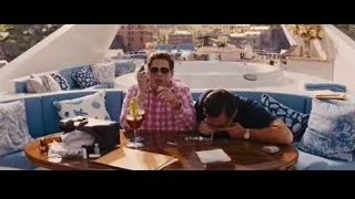 two men on rooftop terrace with city view — The Wolf Of Wall Street