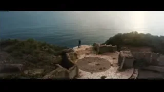 man standing on cliff overlooking ocean — Iron Man 3