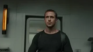 Man with backpack in dimly lit room — Blade Runner 2049