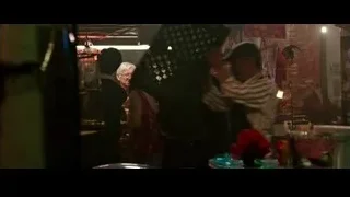Man in black jacket in dim market — Now You See Me 2
