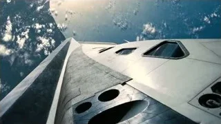 futuristic spaceship floating above Earth — Interstellar
