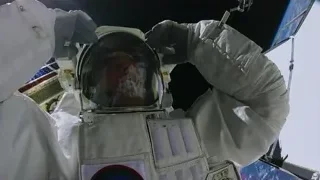 astronaut waving in outer space near satellite — Elon Musk: Return to Space