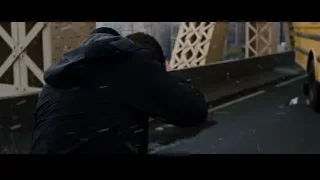 Man on bridge in snowy city — Batman: The Dark Knight Rises